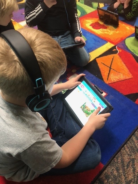 Second grade students engaged with reading nonfiction text through PebbleGo! 