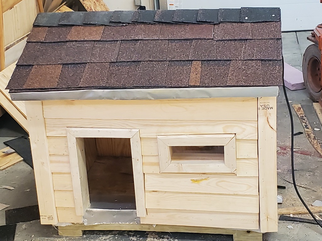 One of the 2 dog houses built by the construction class. Comes insulated and with a light.
