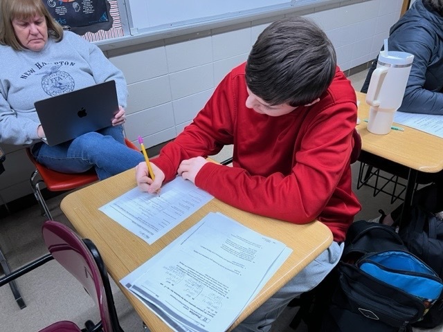Algebra students learned about credit cards and calculated how much an item would really cost if they didn't make any credit card payments for a year or if they made minimum payments for one year.    Below is a picture of Calyb Zeien working on finishing his payments portion of the project.  Kayla Teel is also working along with Mr. Matt Paulus assisting a student.    The second picture is Paul Schwier completing the reflection portion of the project.  Mrs. Russ is observing in the background. 